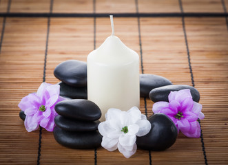 Spa concept: zen stones, candles and flowers