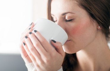 Woman with cup of coffee or tea, portrait