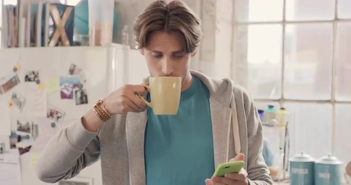 Young student using smart phone at home in  morning drinking coffee