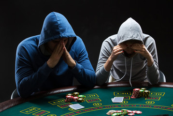 Two professional poker players sitting at a table