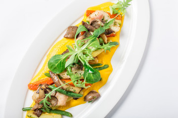 Baked fish King clip with vegetables and sauce. Close-up