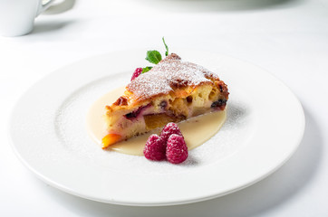 Piece of delicious clafoutis with nectarine and plum