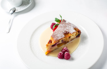 Piece of delicious clafoutis with nectarine and plum