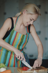 Young woman cutting vegetables