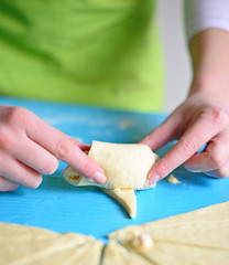 Woman preparing rolls with cheese and ham