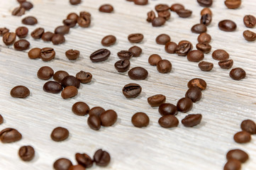 Coffee beans on white wooden background