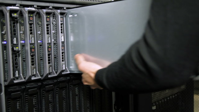 IT consultant inserts blade server