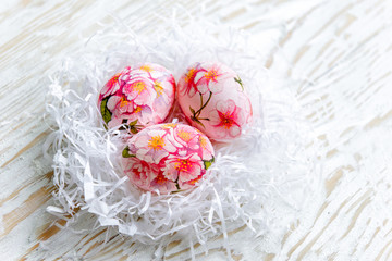 Decorated with painted Easter eggs and flowers on a light background