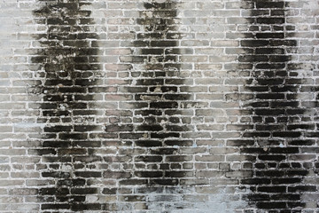 dirty old brick wall with black stain on wall background