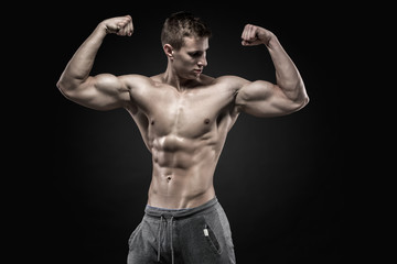 Fototapeta na wymiar Fitness man model torso posing and showing perfect body