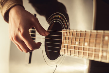 Woman playing guitar close-up shot