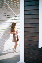 beautiful girl posing on a background of a wooden wall