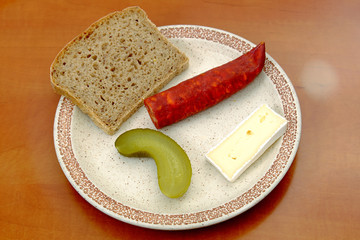 Sausages with a slice of bread cheese and pickle