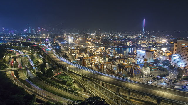 Hong Kong Skyline and Container Terminal at Night timelapse - Hong Kong Kwai Tsing Container Terminals is one of the busiest ports in the world.