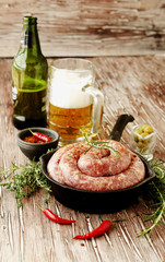 raw beef sausages on a cast-iron pan,  selective focus