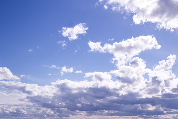 Fototapeta premium Fluffy white clouds and clear blue sky 