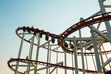Theme Park Rollercoaster against blue sky .