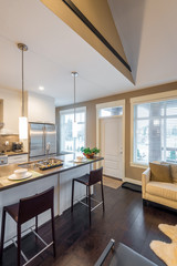 Modern, bright, clean, kitchen interior with stainless steel appliances in a luxury house