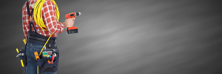 Electrician with drill and cable.