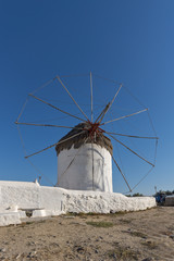 Fototapeta na wymiar White windmill and medieval wall on the island of Mykonos, Cyclades, Greece