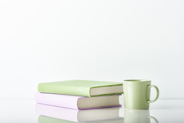 Books with a coffee cup. On white background with copy space.
