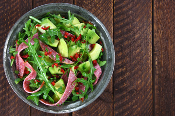 Salad with arugula, salami and avocado