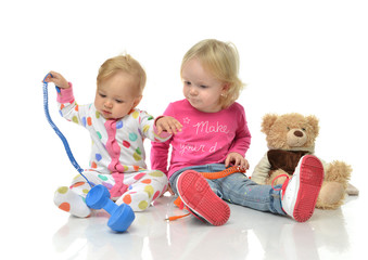 Kids play at home. Children playing with phones Little girl havi