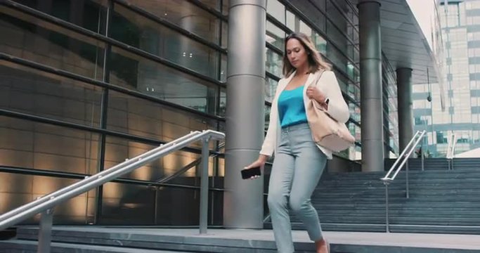 Beautiful mixed race business woman walking through city