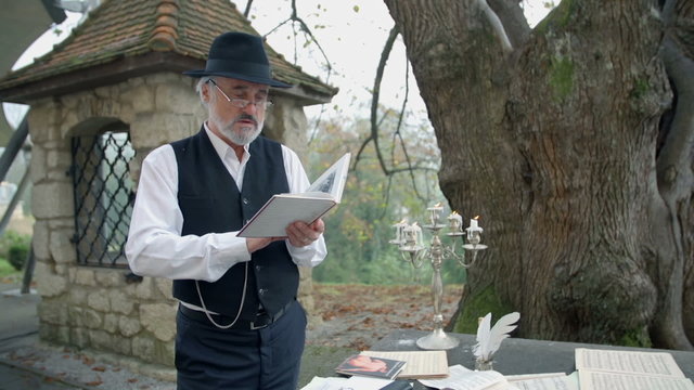 Man reading a poem standing on the garden