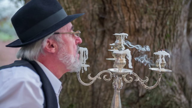 Man blowing the candles on the garden 