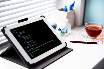 Programming code on tablet computer monitor
