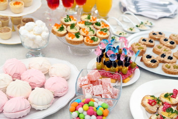 Set of cold snacks, canape, beverages and dessert, closeup