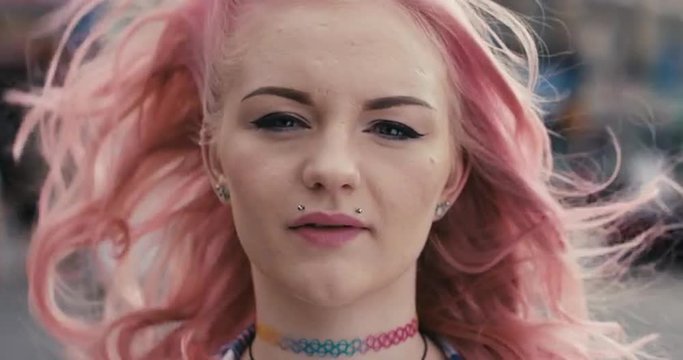 Slow Motion Portrait of caucasian girl with pink hair
