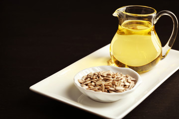 Sunflower seeds with oil on wooden table