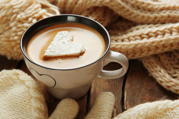 Cup of coffee with marshmallow on wooden table