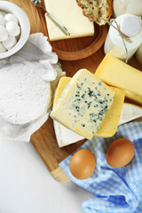 Set of fresh dairy products on white wooden table