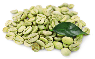 Heap of green coffee beans with leaf isolated on white
