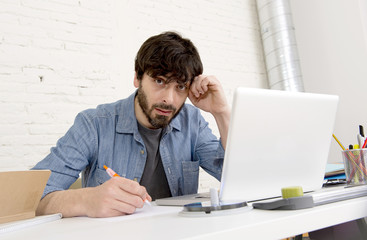 young hispanic hipster businessman working at computer home office