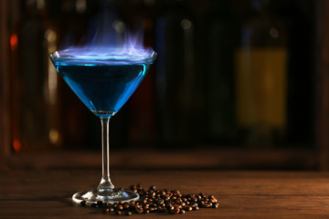 Burning cocktail on table in a bar