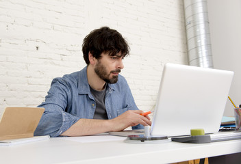 young hispanic hipster businessman working at computer home office