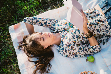Girl lying in the park and reading