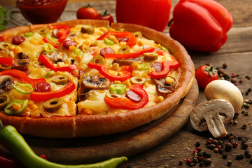 Delicious sliced pizza with vegetables, close-up