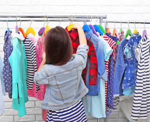 Little girl trying on a new shirt