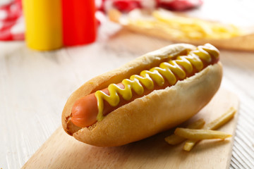Hot dog with fried potatoes on craft paper