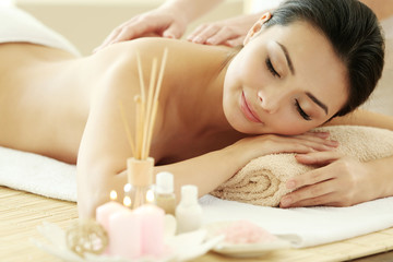 Fototapeta na wymiar Masseur doing massage on woman back in the spa salon