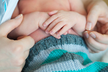 mother hands holding little arms newborn son