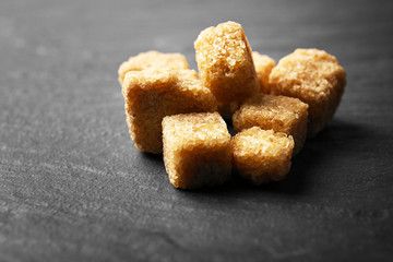 Pile of brown sugar cubes on the table