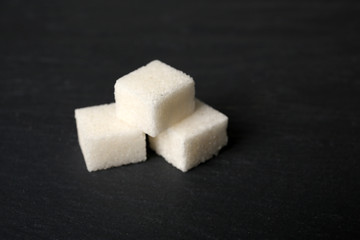 Pile of sugar cubes on the table