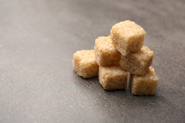 Pile of brown sugar cubes on the table
