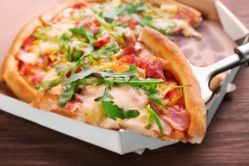 Sliced fresh pizza on wooden table closeup